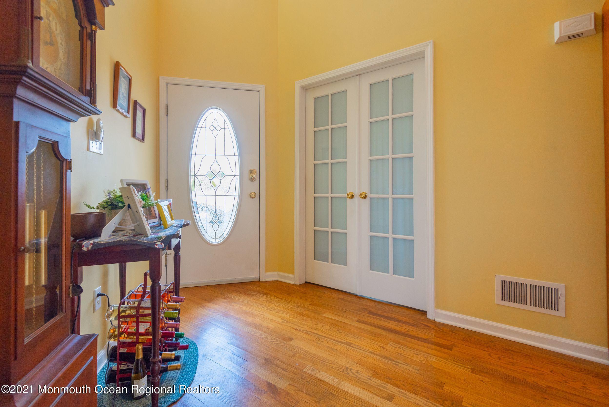 94 Cedar Run Road Bayville, NJ 08721 - Photo 10 of 43 a view of a room with wooden floor potted plant and windows