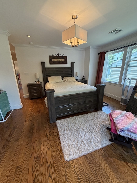 17 Cardinal Street, Unit 17 Winchester, MA 01890 - Photo 16 of 42 a bedroom with a bed and a chandelier