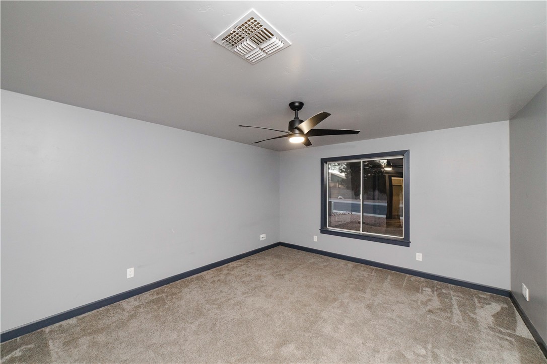 3374 Roma Road Kingman, AZ 86401 - Photo 27 of 64 Unfurnished room featuring carpet floors and ceiling fan