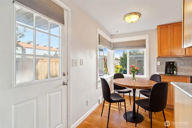 a view of a dining room with furniture and a window