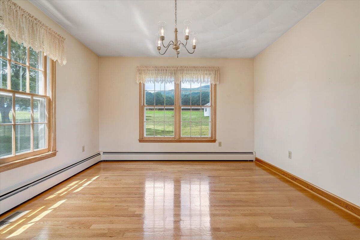 2324 Camp Jaycee Road Blue Ridge, VA 24064 - Photo 10 of 74 a view of empty room with wooden floor and fan