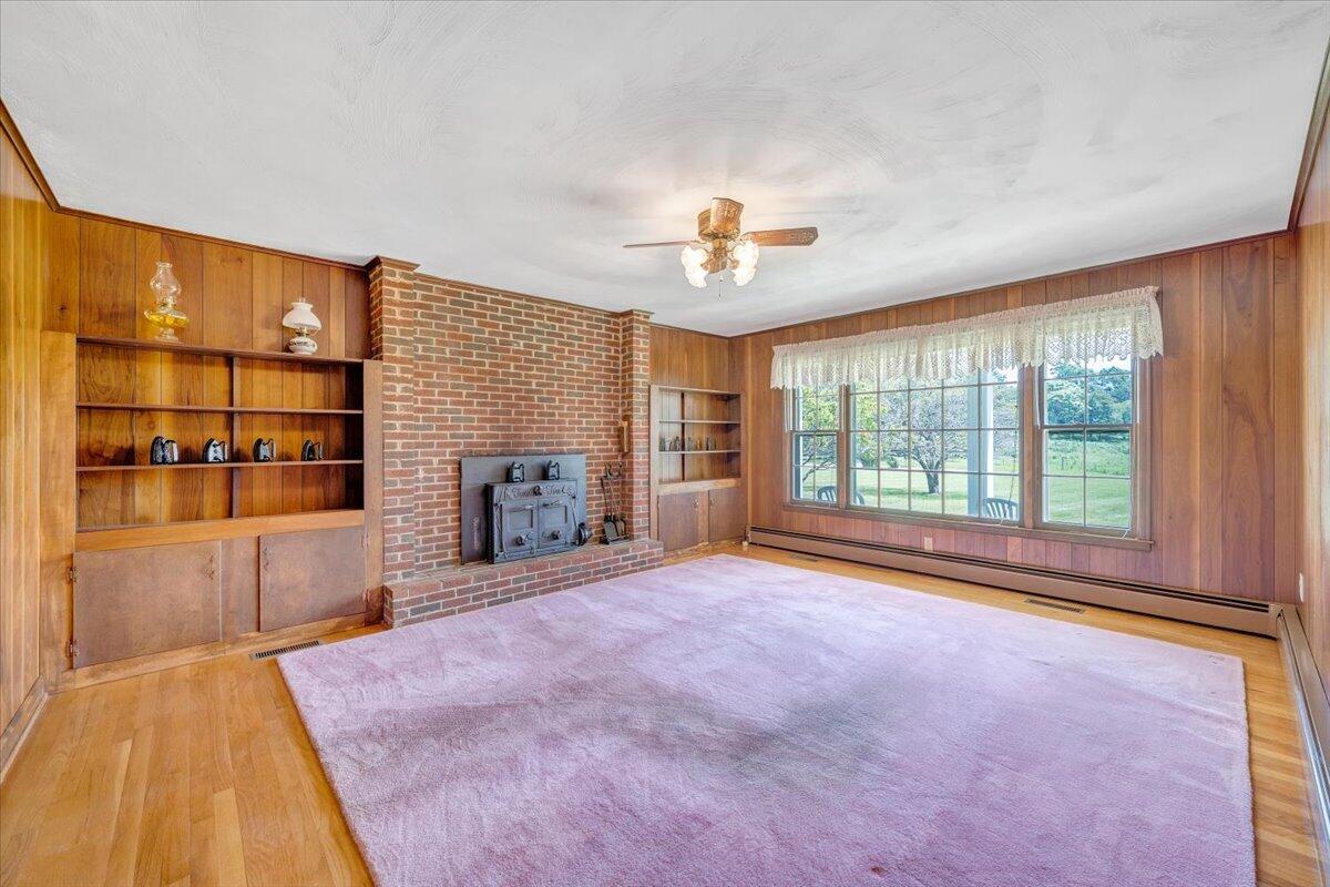 2324 Camp Jaycee Road Blue Ridge, VA 24064 - Photo 23 of 74 a view of an empty room with a fireplace and a window