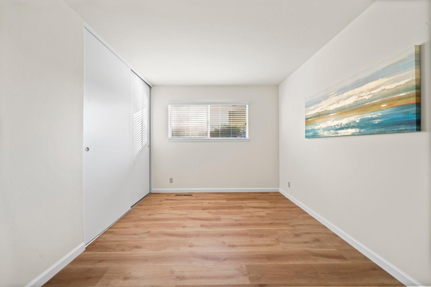 1574 Bittern Drive Sunnyvale, CA 94087 - Photo 14 of 36 a view of an empty room with wooden floor and windows
