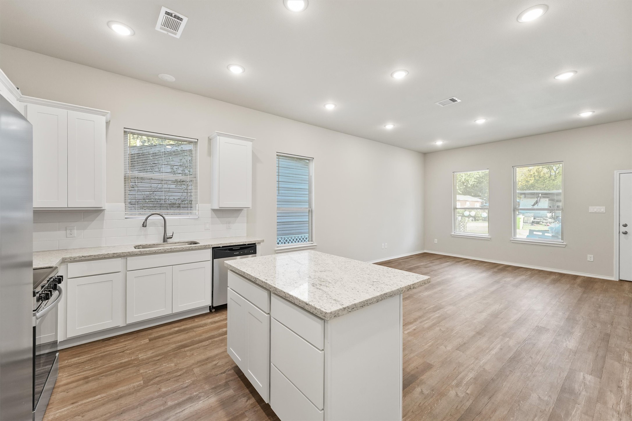 8687 Sassafras Willis, TX 77318 - Photo 11 of 32 a kitchen with a sink stove and cabinets