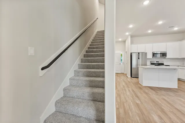 a view of kitchen with wooden floor and electronic appliances