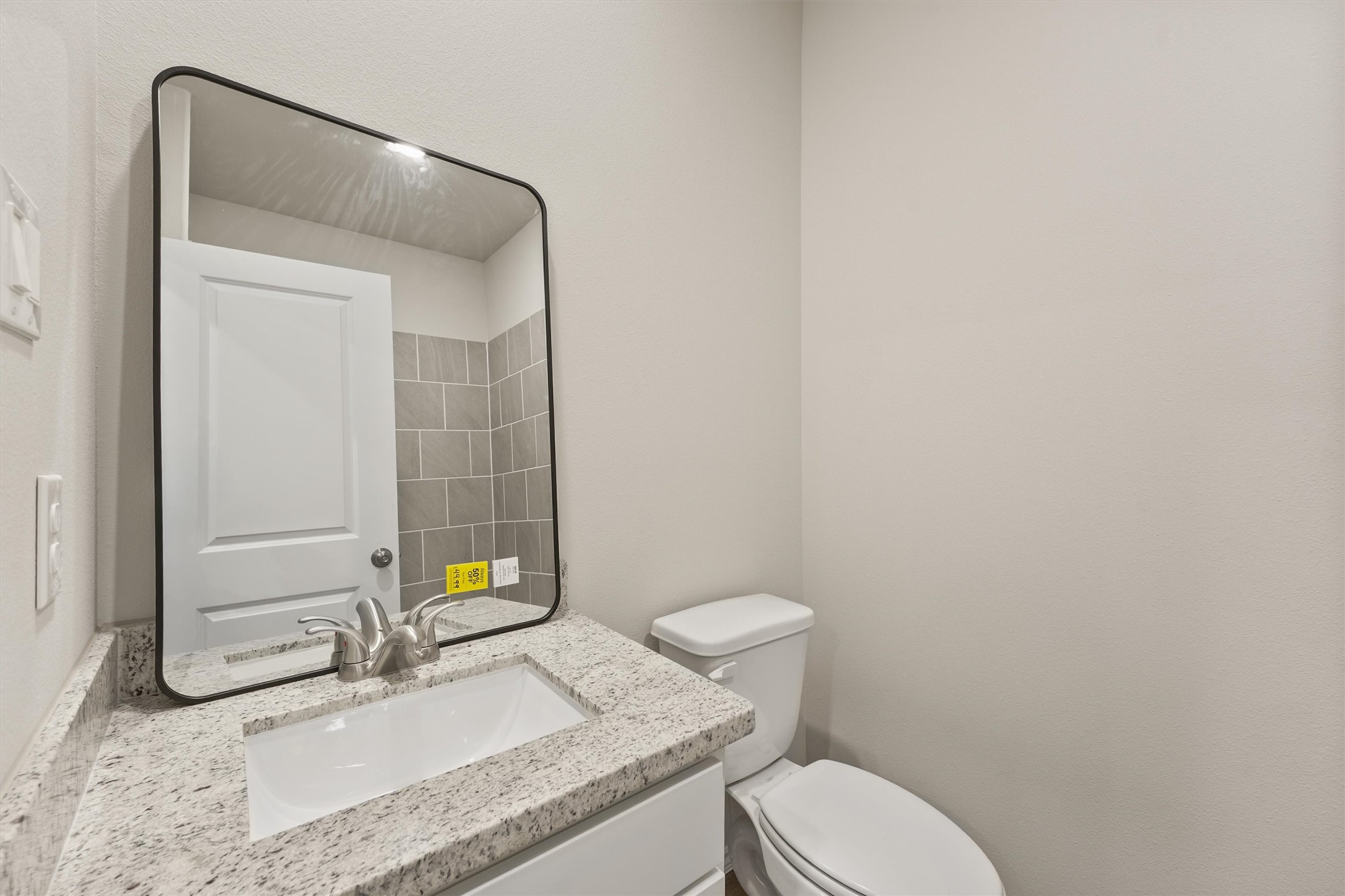 8687 Sassafras Willis, TX 77318 - Photo 20 of 32 a bathroom with a granite countertop sink and a mirror