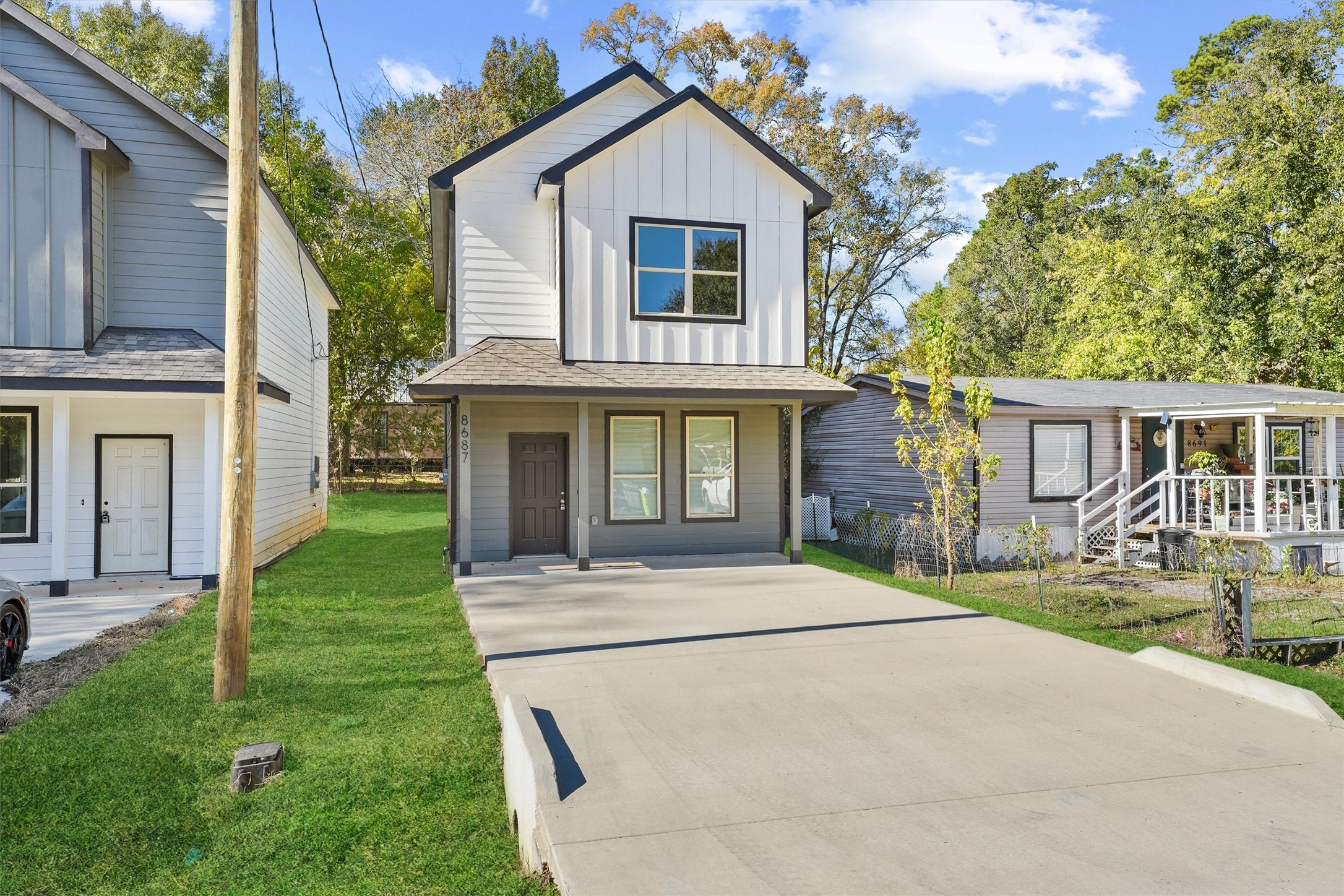 8687 Sassafras Willis, TX 77318 - Photo 2 of 32 a front view of house with yard and green space