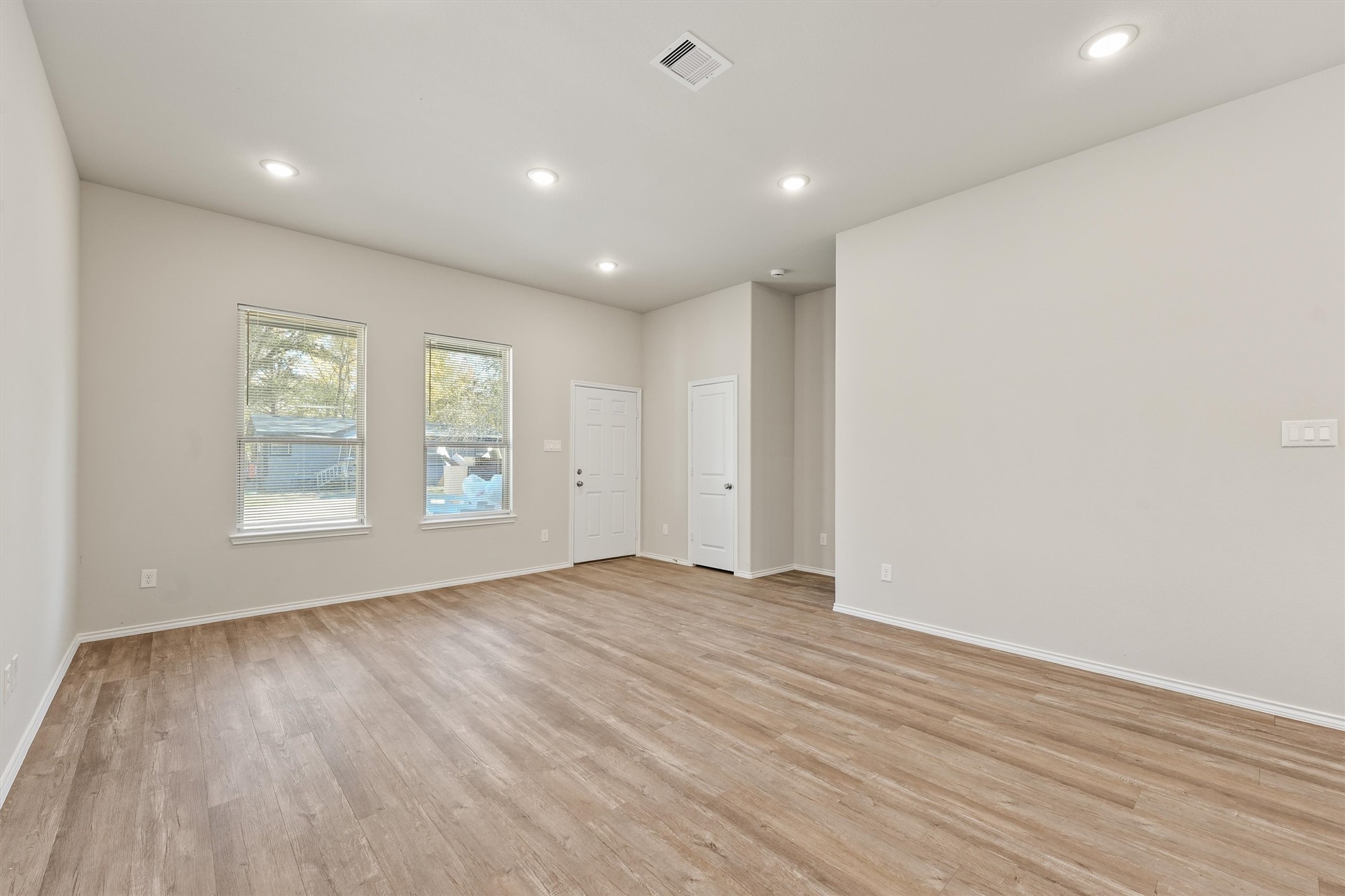 8687 Sassafras Willis, TX 77318 - Photo 6 of 32 wooden floor in an empty room with a window