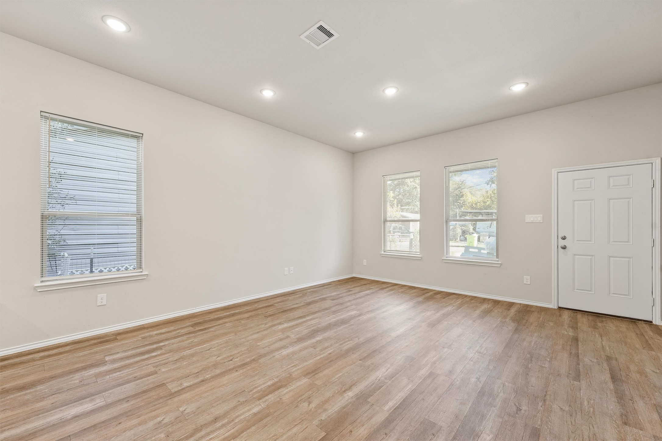 8687 Sassafras Willis, TX 77318 - Photo 8 of 32 a view of an empty room with wooden floor and a window