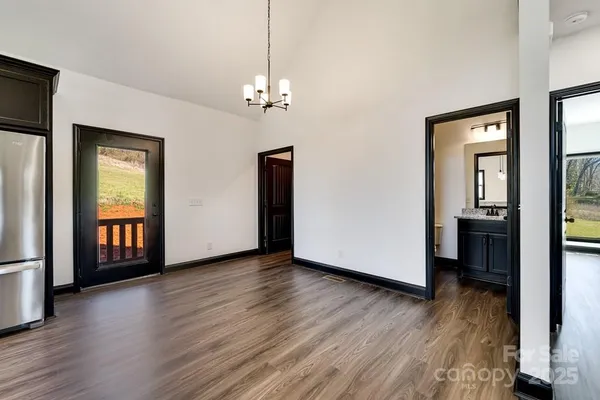 a view of livingroom with hardwood floor and kitchen view