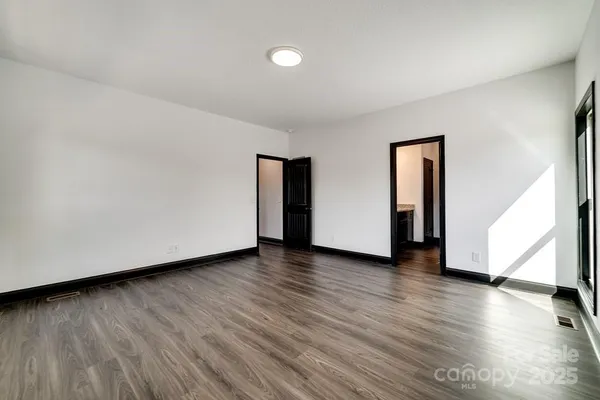 a view of a livingroom with wooden floor and stairs