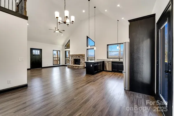 a view of a kitchen with furniture and a refrigerator