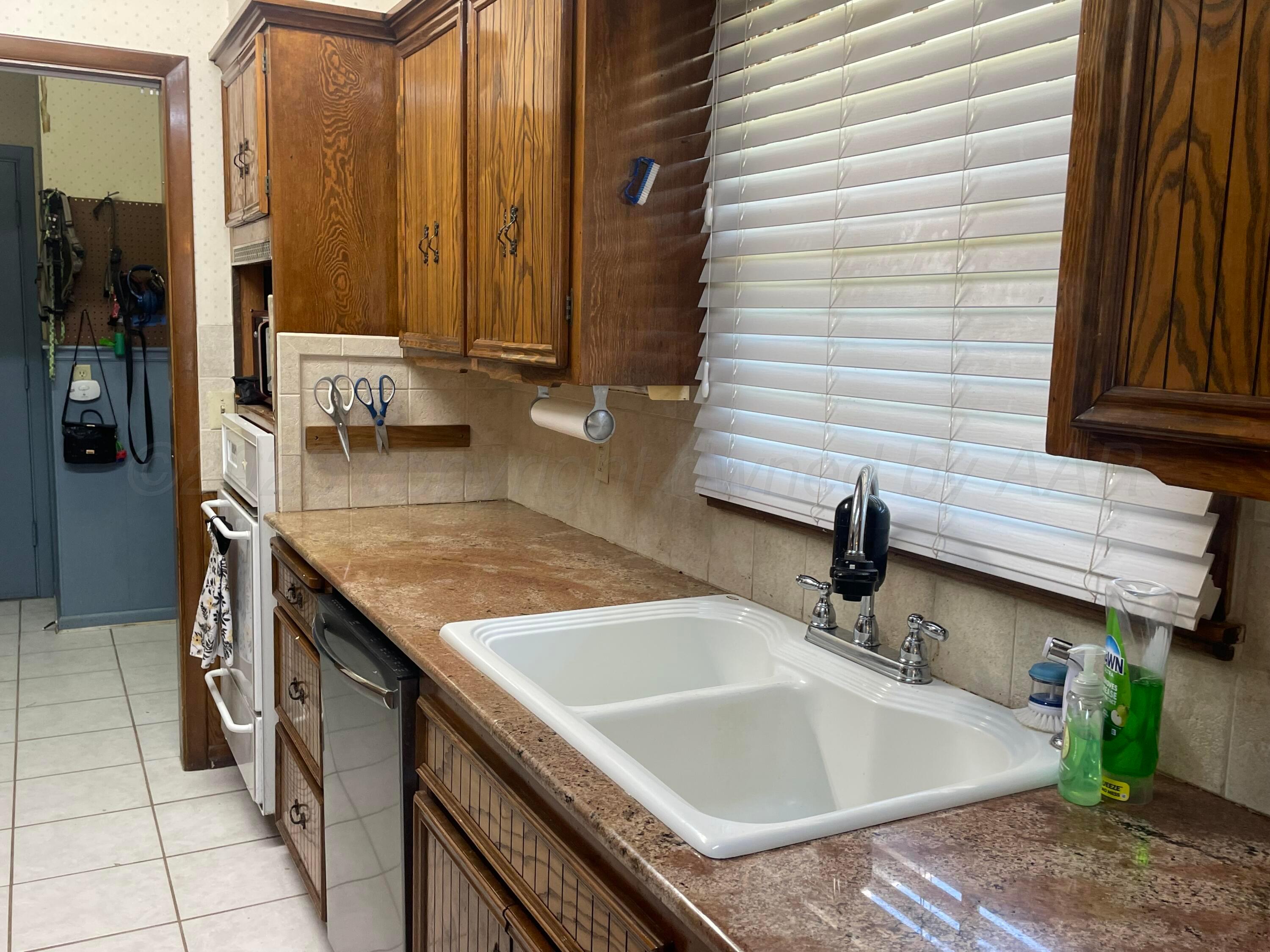 6200 Hanson Road Amarillo, TX 79106 - Photo 6 of 27 a bathroom with a granite countertop sink and a mirror