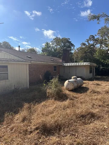 a view of a backyard with table and chairs