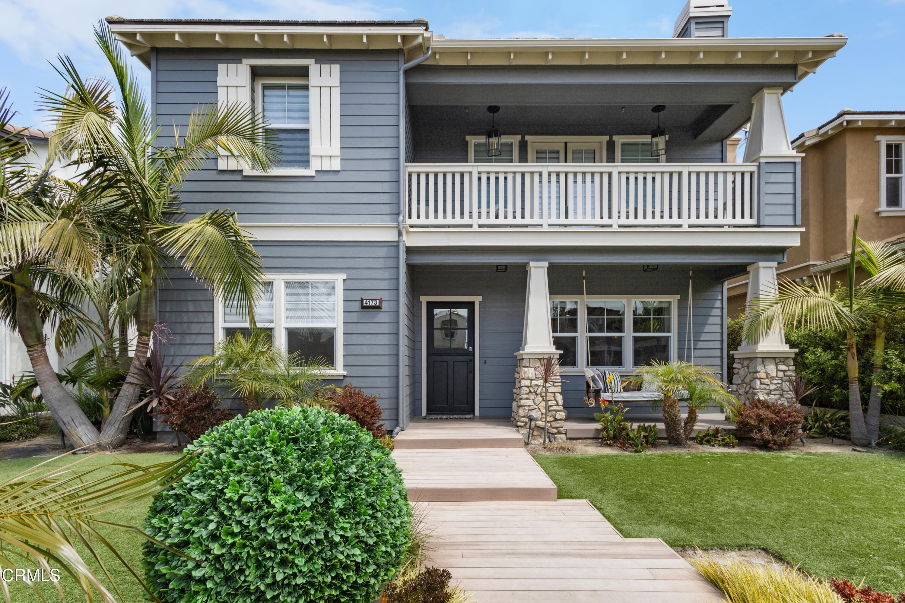 a view of a house with a garden and pathway