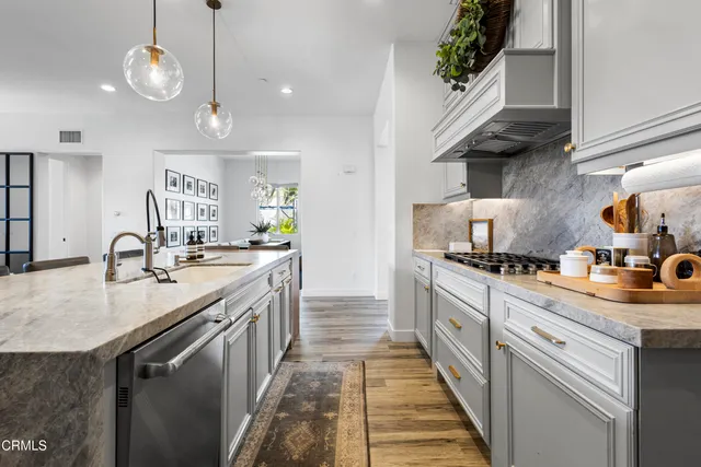 a kitchen with a sink stove and cabinets