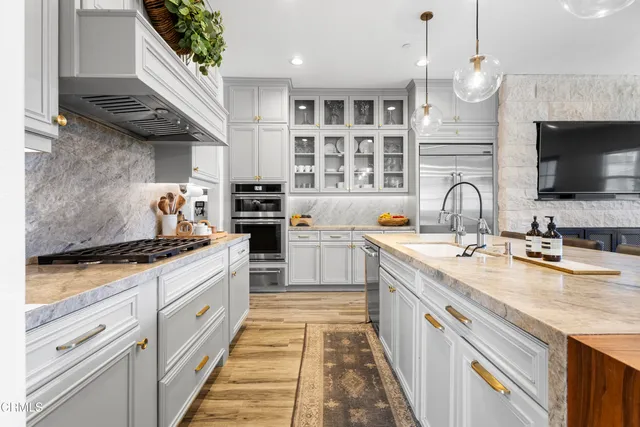 a kitchen with a sink a refrigerator and cabinets