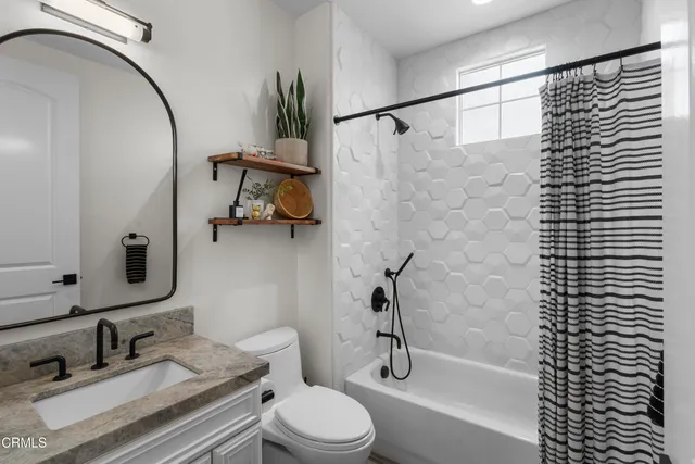 a view of a hallway with furniture and wooden floor