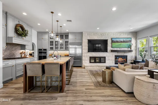 a living room with fireplace furniture and a flat screen tv