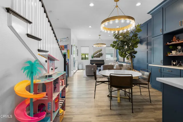 a living room with furniture potted plant and a chandelier