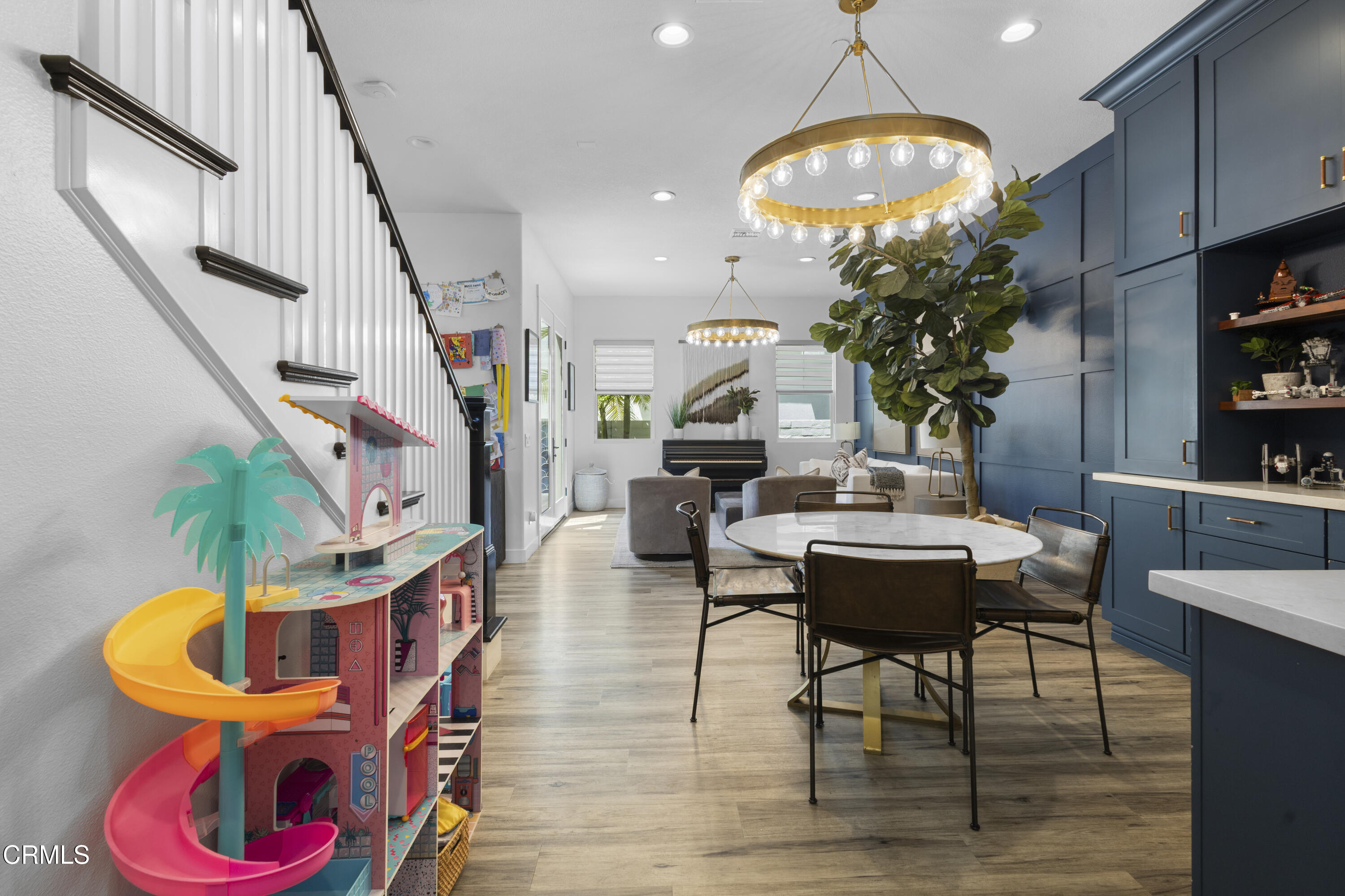 4173 Caribbean Street Oxnard, CA 93035 - Photo 22 of 64 a living room with furniture a chandelier and a potted plant