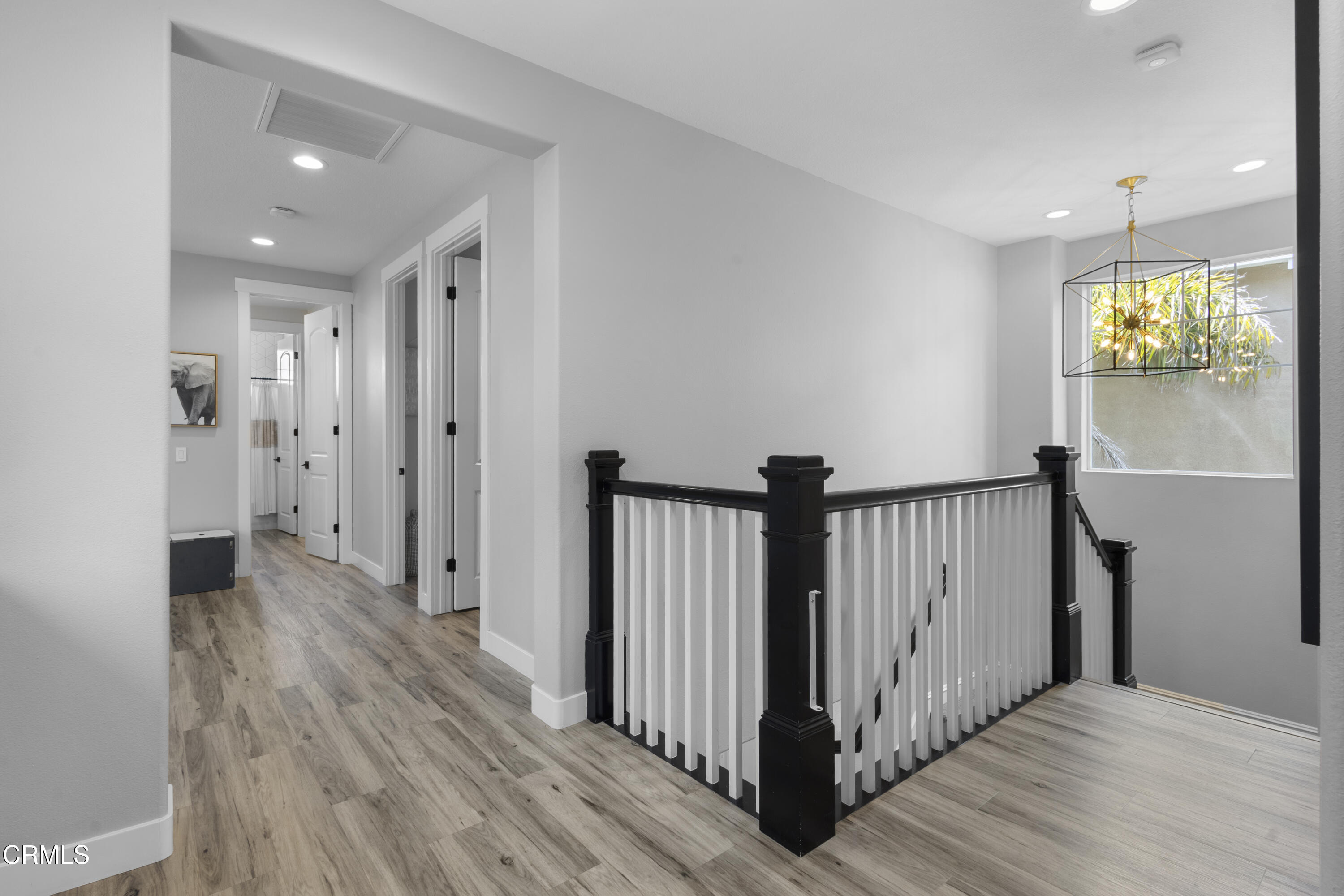 4173 Caribbean Street Oxnard, CA 93035 - Photo 24 of 64 a view of a hallway with wooden floor and windows