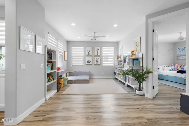 a living room with furniture a wooden floor and a table