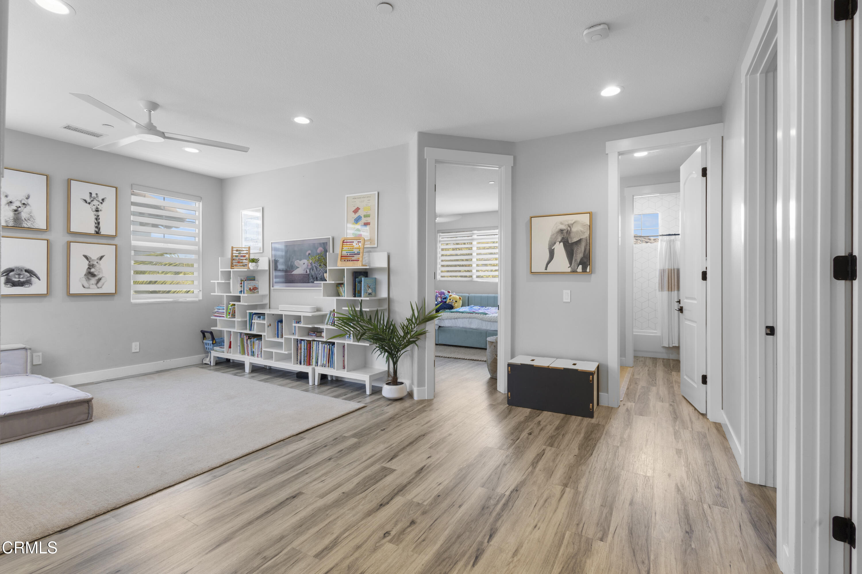 4173 Caribbean Street Oxnard, CA 93035 - Photo 26 of 64 a living room with furniture a wooden floor and a table