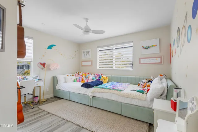 a view of a hallway with wooden floor and a potted plant