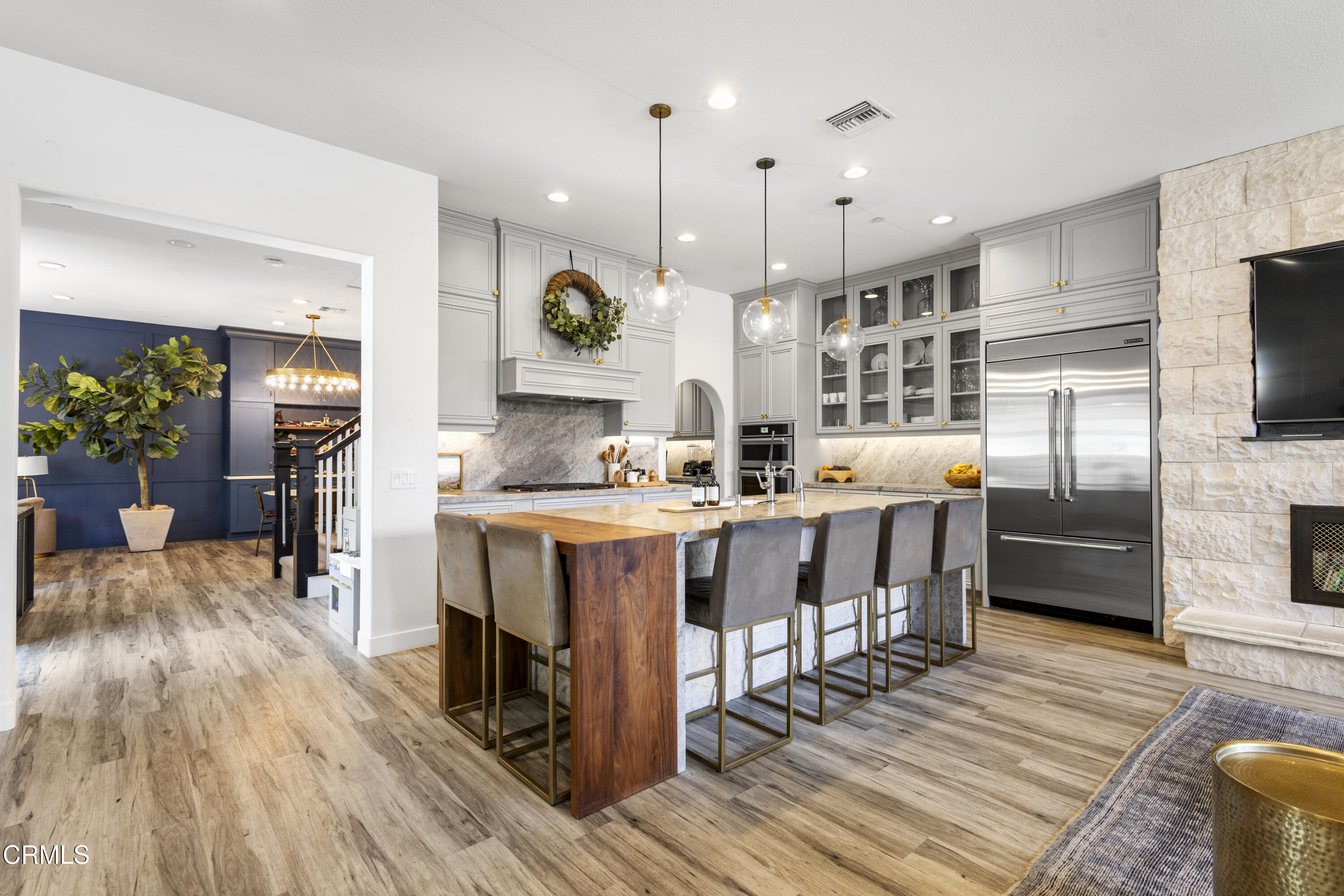 4173 Caribbean Street Oxnard, CA 93035 - Photo 3 of 64 a kitchen with stainless steel appliances kitchen island granite countertop a table chairs and a refrigerator