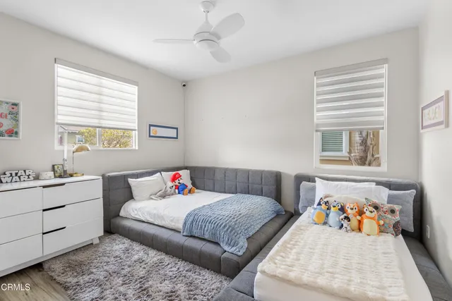 a spacious bedroom with a bed and a flat screen tv