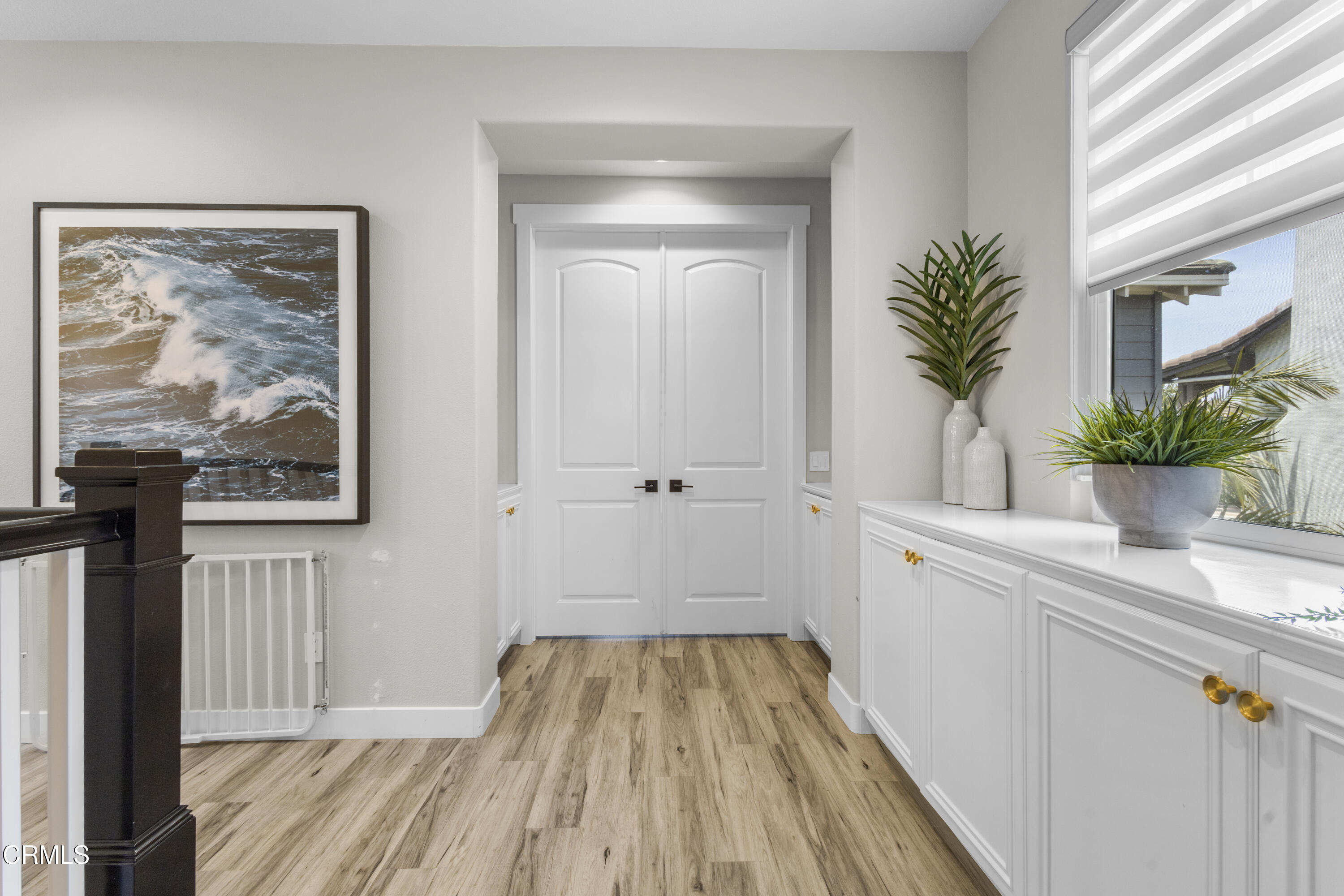 4173 Caribbean Street Oxnard, CA 93035 - Photo 33 of 64 a view of a hallway with wooden floor and a potted plant