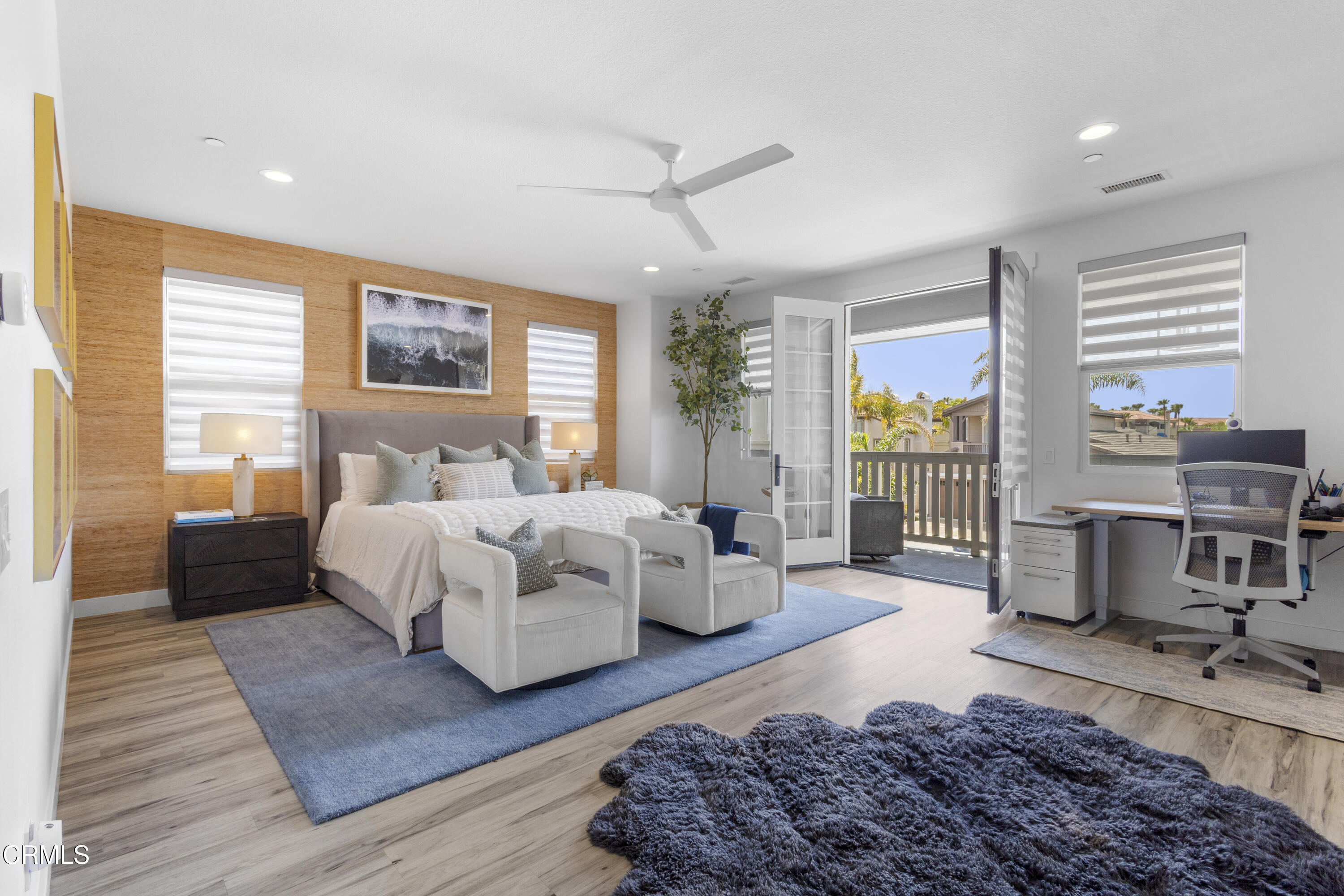 4173 Caribbean Street Oxnard, CA 93035 - Photo 34 of 64 a bedroom with a large bed a large window with table and chairs