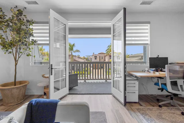 a living room with a fireplace and a potted plant