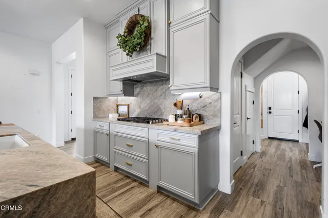 a kitchen with cabinets and wooden floor