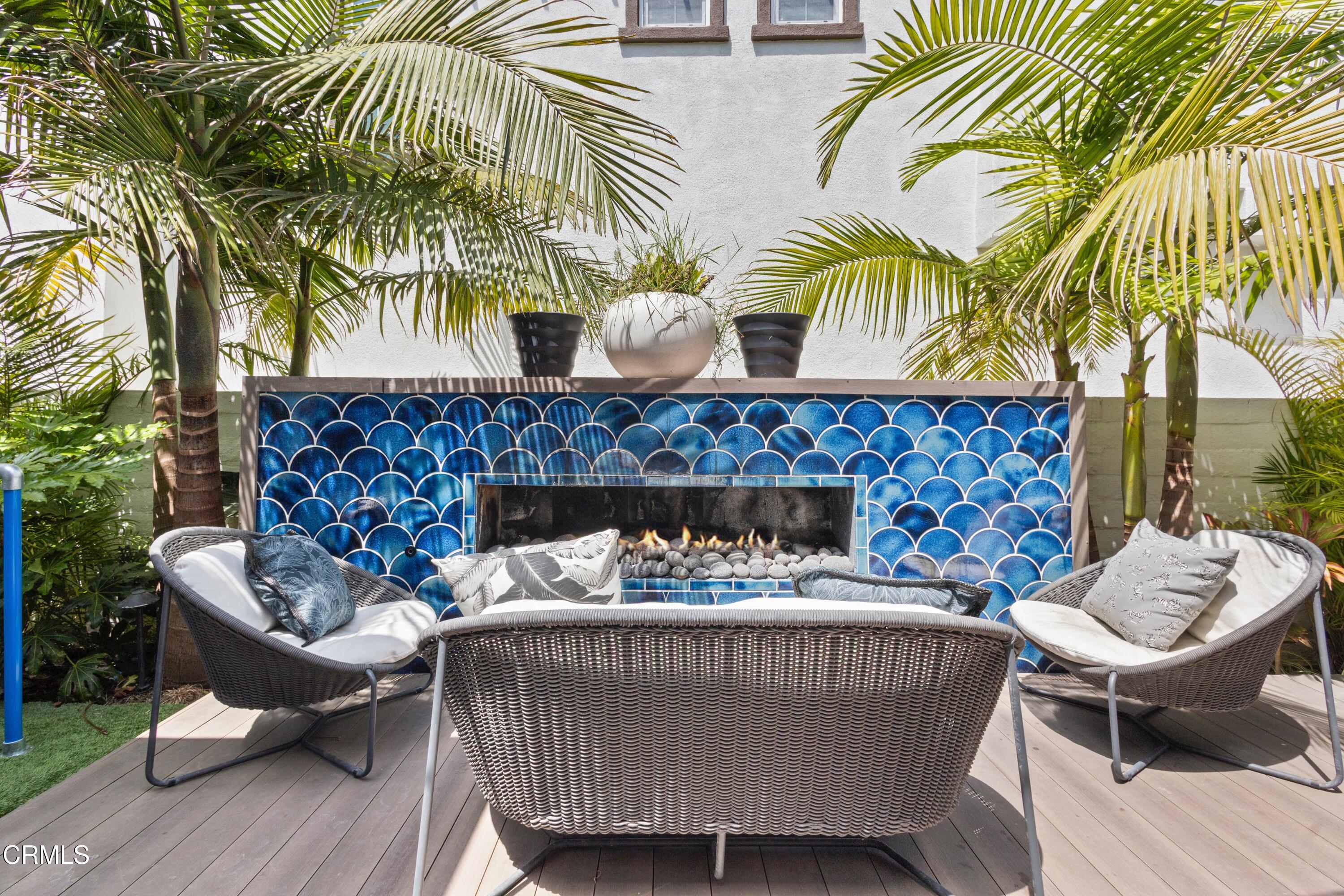 4173 Caribbean Street Oxnard, CA 93035 - Photo 44 of 64 a view of a patio with a table and chairs and a fire pit