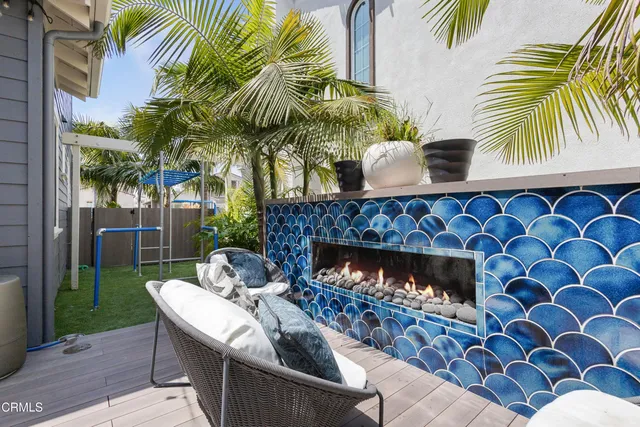 a view of a swimming pool with a bench and trees around