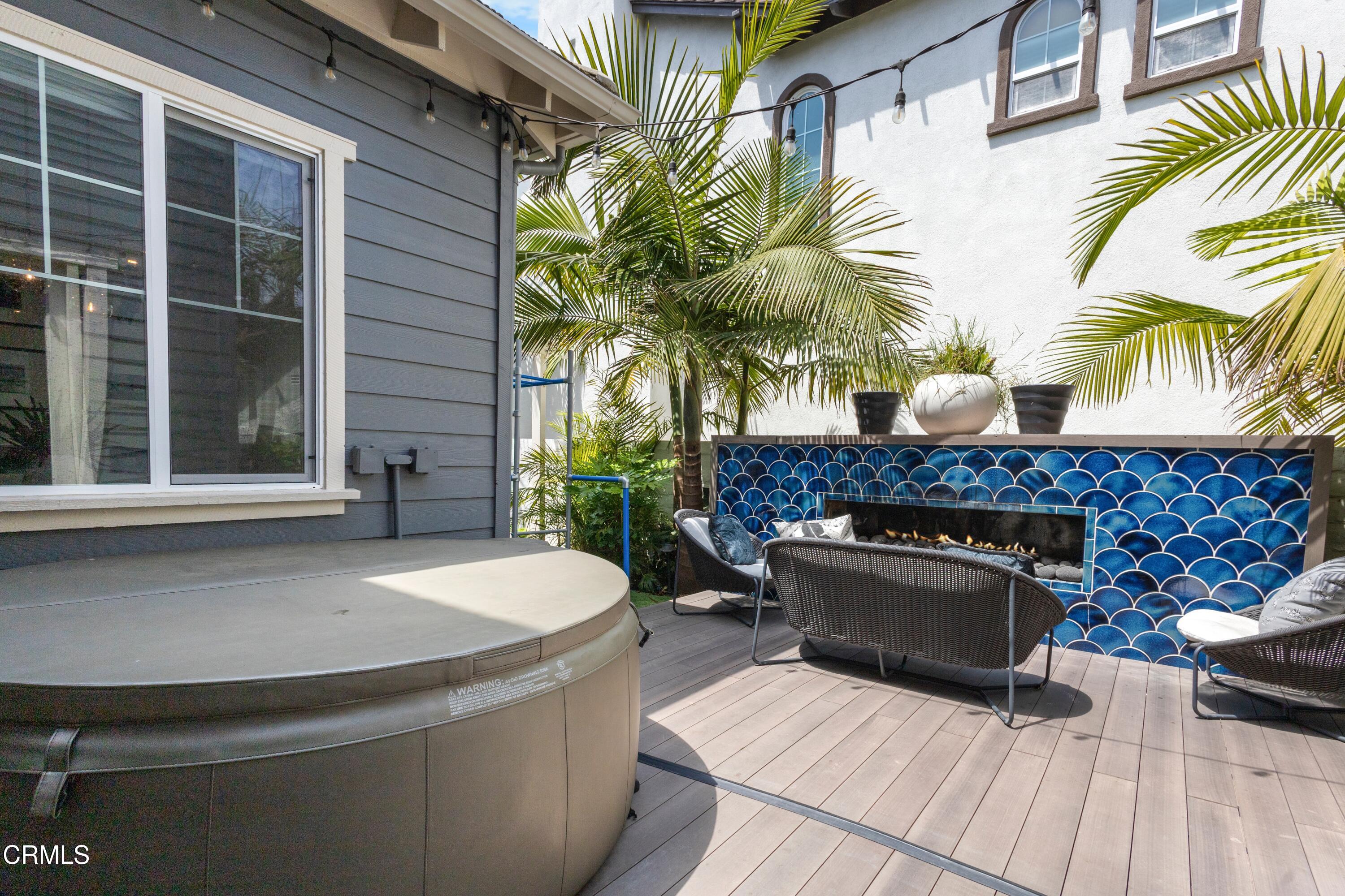4173 Caribbean Street Oxnard, CA 93035 - Photo 47 of 64 a living room with a fireplace and a potted plant