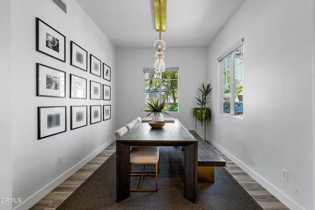 a living room with kitchen island furniture and a chandelier