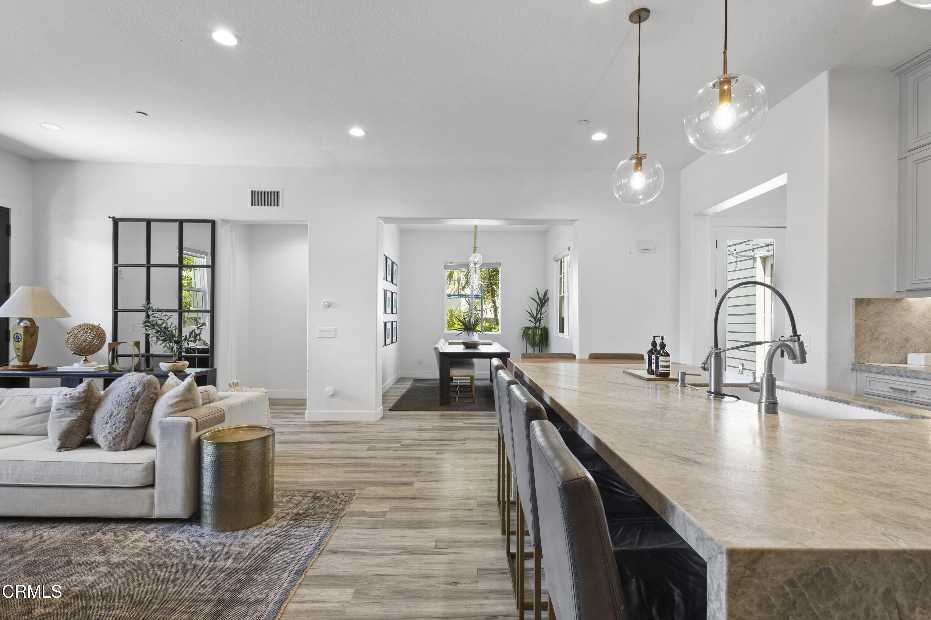 4173 Caribbean Street Oxnard, CA 93035 - Photo 10 of 64 a living room with kitchen island furniture and a chandelier