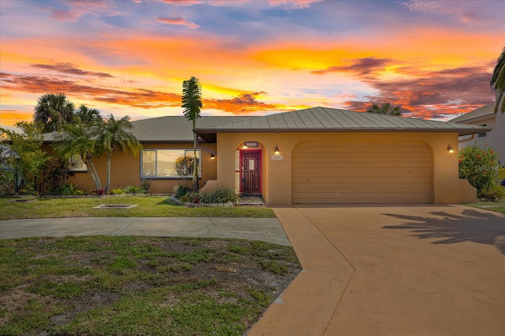 5000 South Shore Drive New Port Richey, FL 34652 - Photo 1 of 1 a front view of a house with a yard and a garage