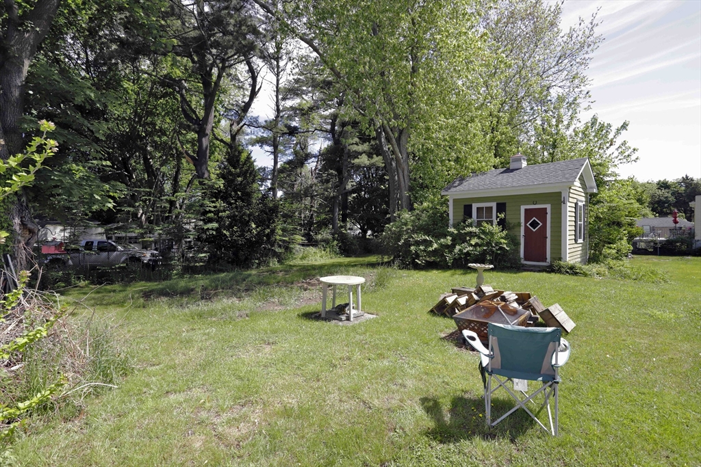 5 Anthony Street Acushnet, MA 02743 - Photo 10 of 37 a front view of a house with a yard table and chairs