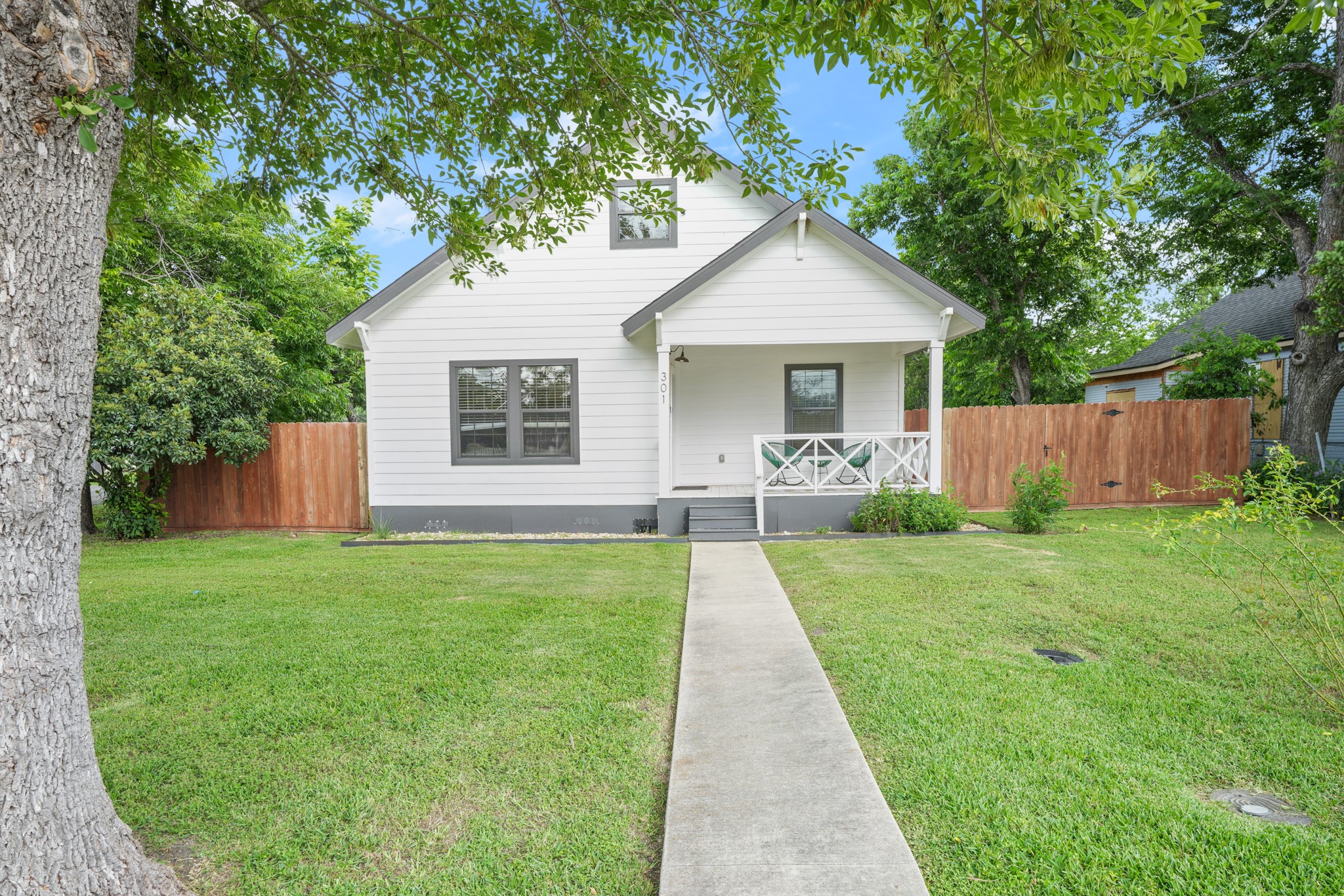 301 Old Thorndale Road Taylor, TX 76574 - Photo 3 of 29 A charming cottage facade with a welcoming front porch and mature trees frames this inviting home.