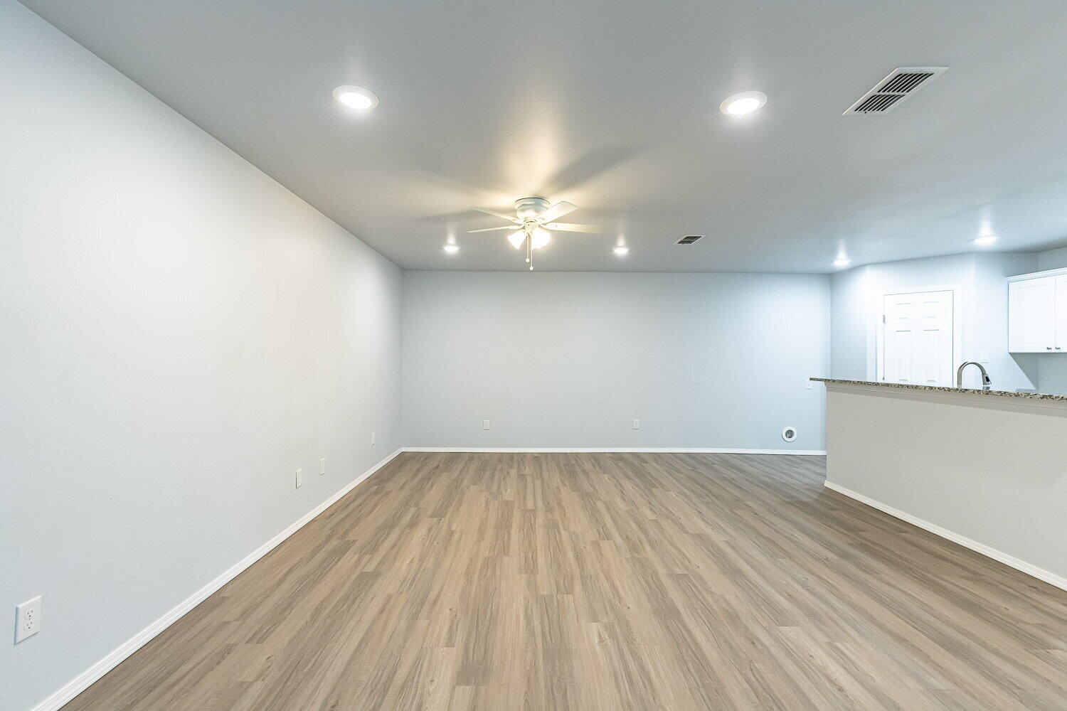5517 Kemper Street, Unit A Lubbock, TX 79416 - Photo 12 of 25 an empty room with wooden floor and windows
