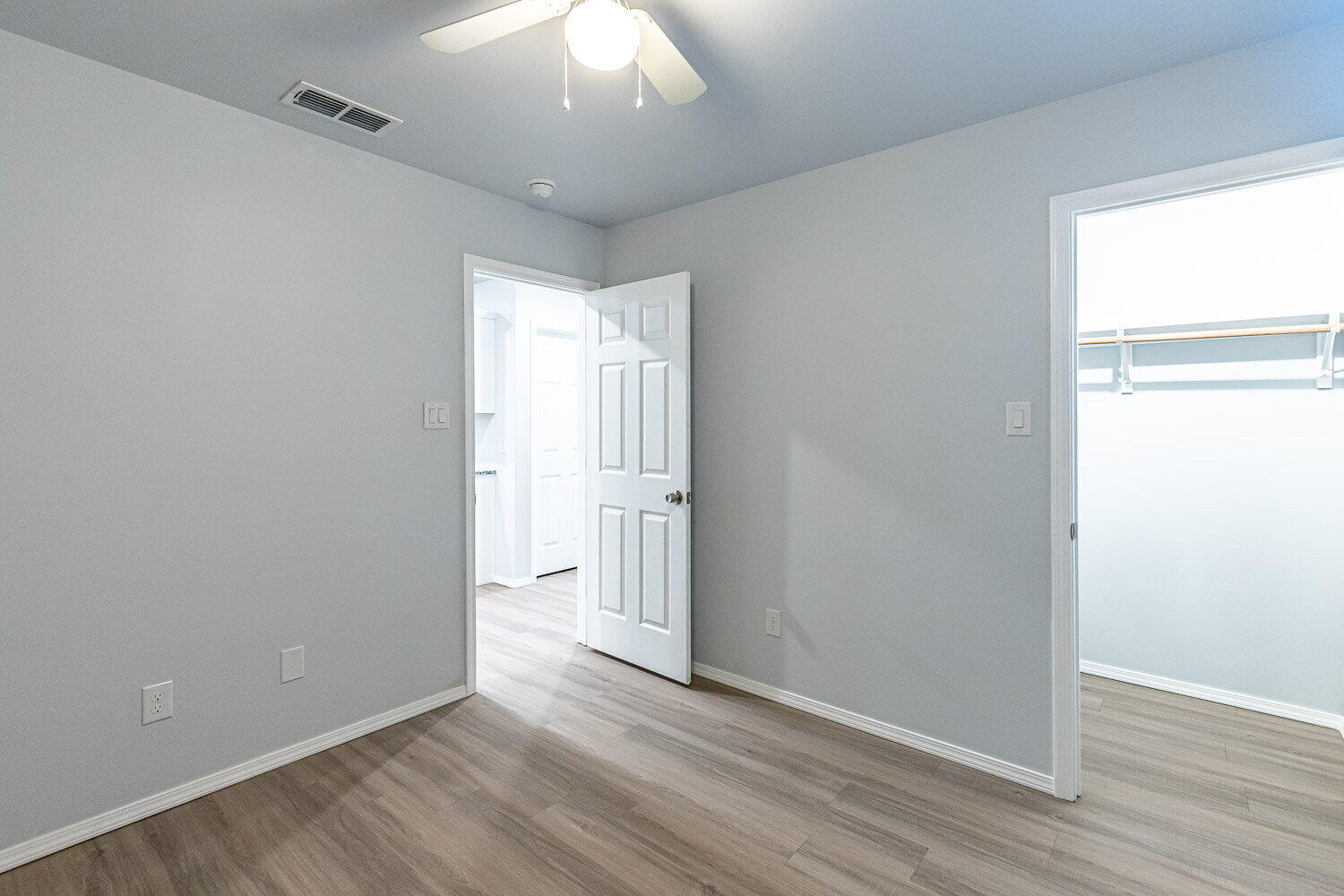 5517 Kemper Street, Unit A Lubbock, TX 79416 - Photo 14 of 25 an empty room with wooden floor and windows