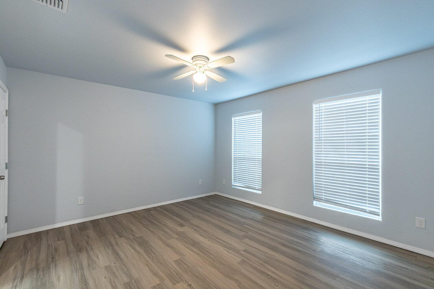 5517 Kemper Street, Unit A Lubbock, TX 79416 - Photo 16 of 25 a view of an empty room with wooden floor and a window