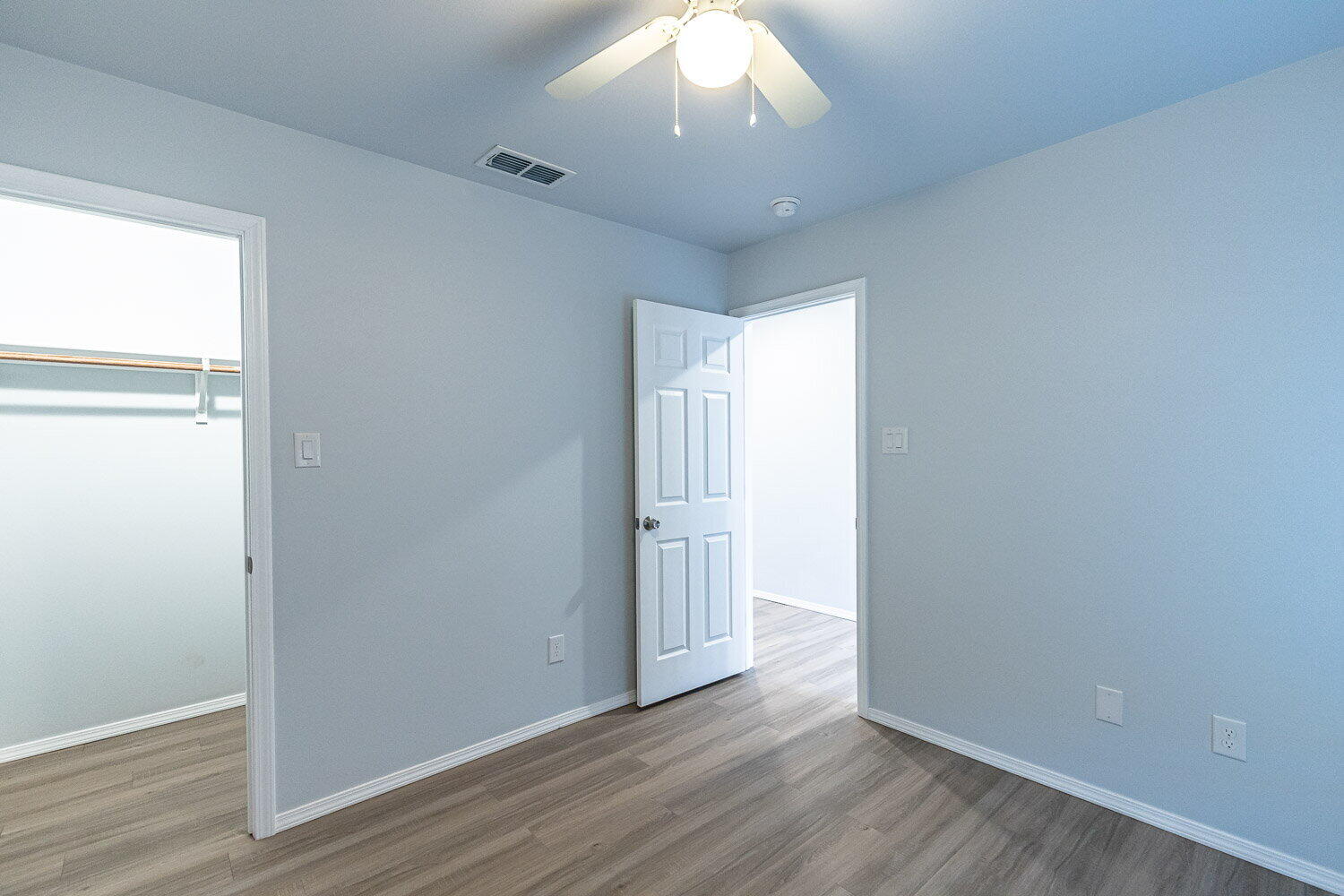 5517 Kemper Street, Unit A Lubbock, TX 79416 - Photo 19 of 25 an empty room with wooden floor and windows