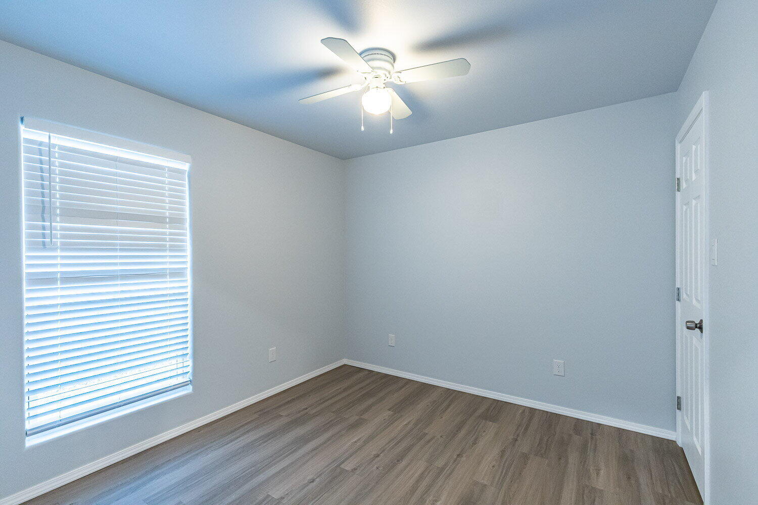 5517 Kemper Street, Unit A Lubbock, TX 79416 - Photo 20 of 25 wooden floor in an empty room with a window