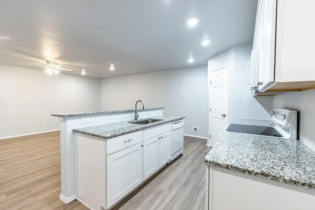 a kitchen with a sink stove and cabinets