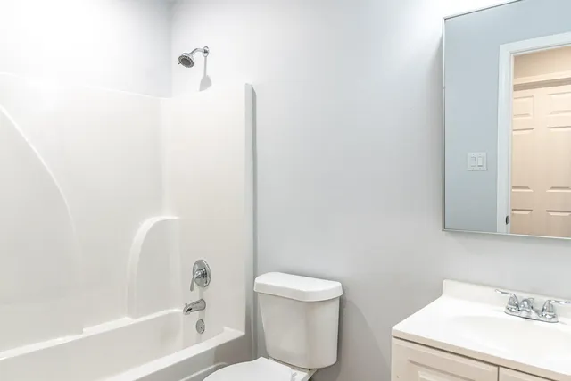 a bathroom with a toilet and a bathtub